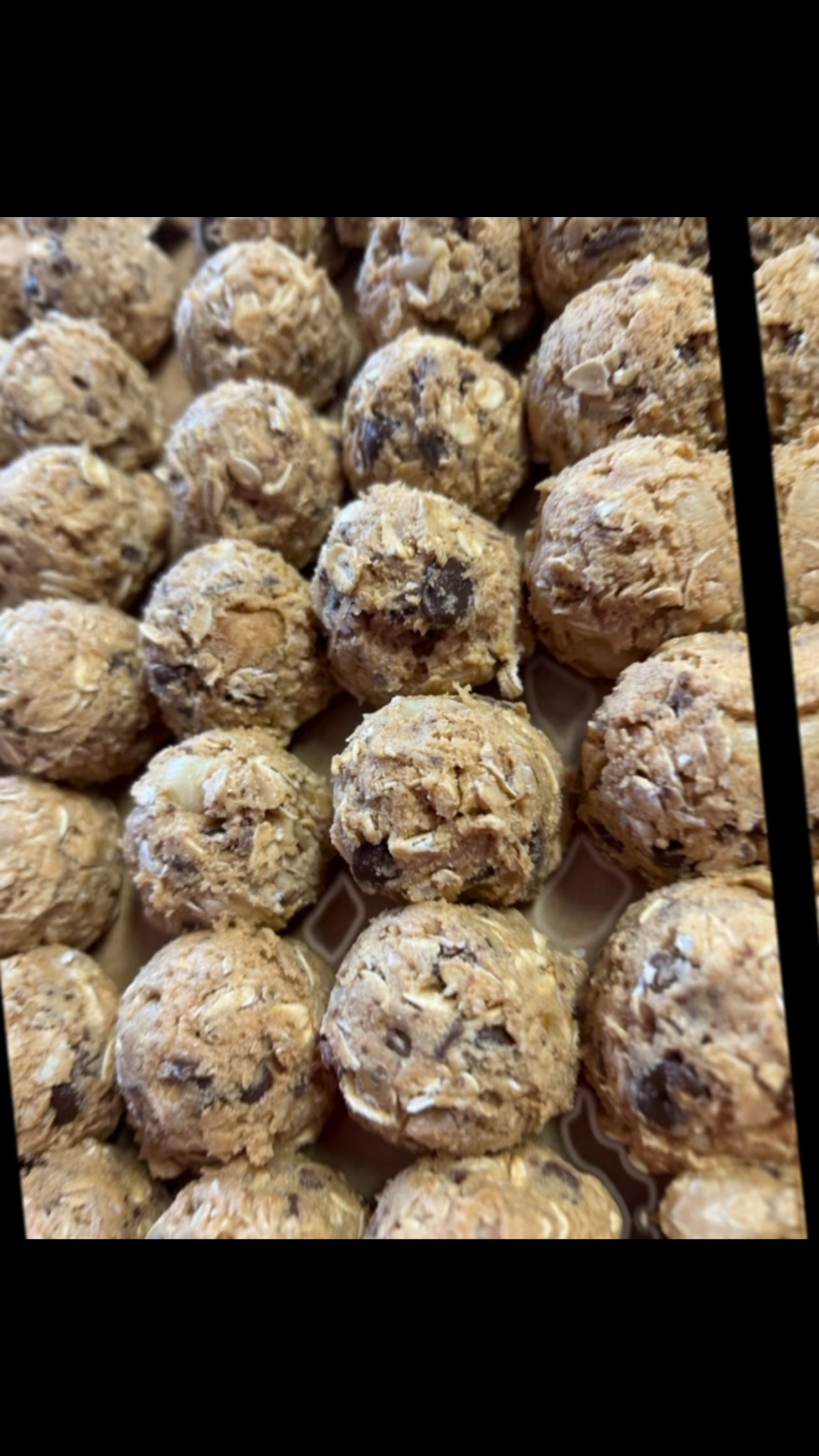 Close-up of chocolate chip protein bombs on a baking tray