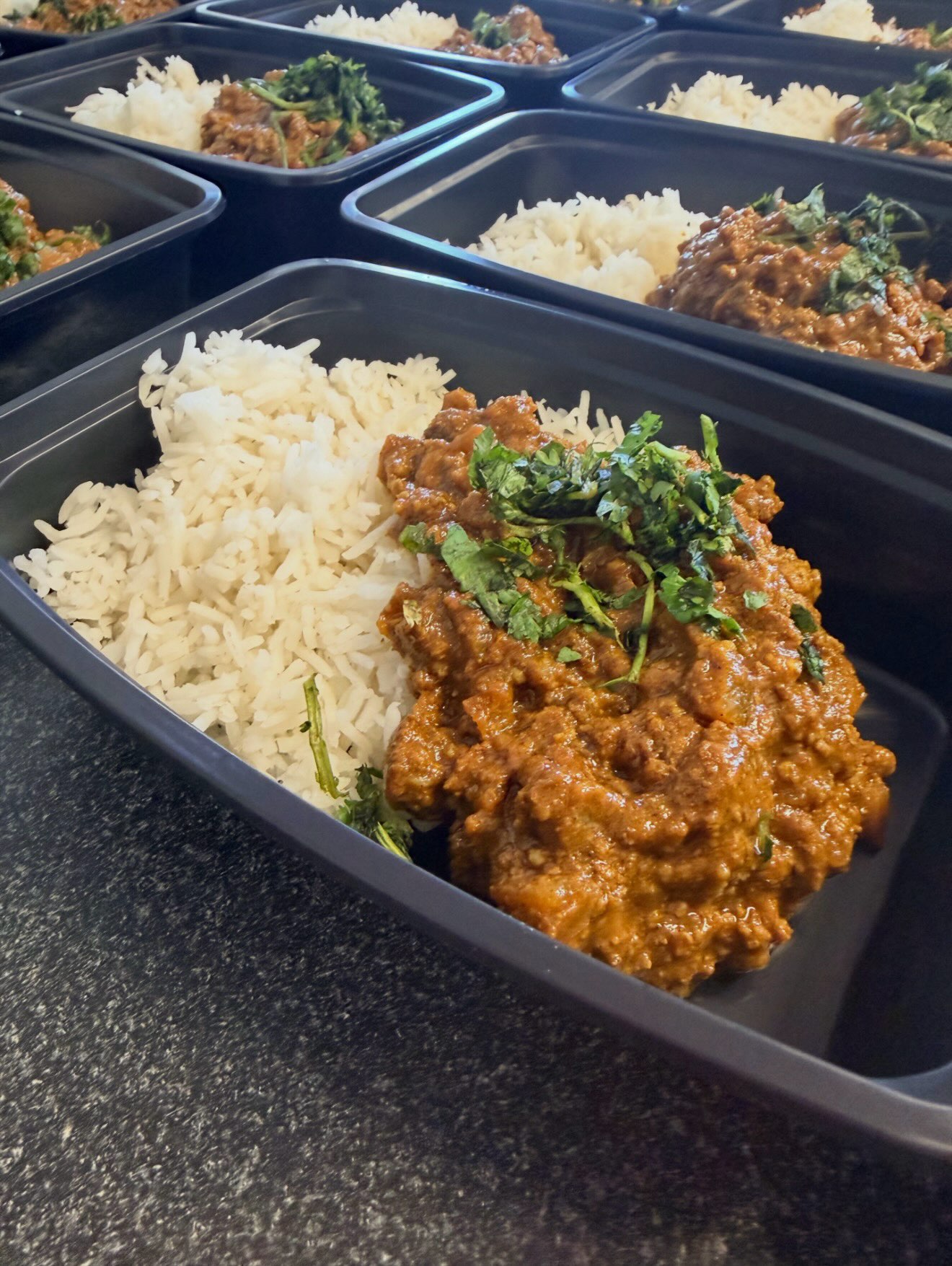 Keema curry over basmati rice topped with fresh cilantro